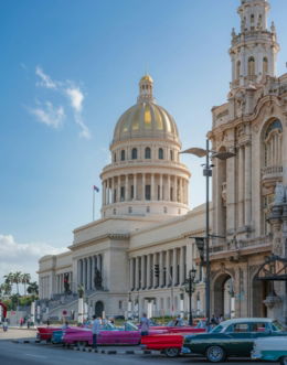 people walking on sidewalk near white concrete building during daytime
